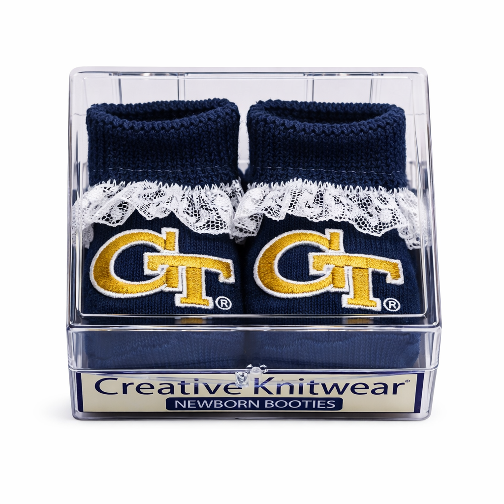 Navy newborn booties with lace trim and GT logo in a clear box, branded as Creative Knitwear.